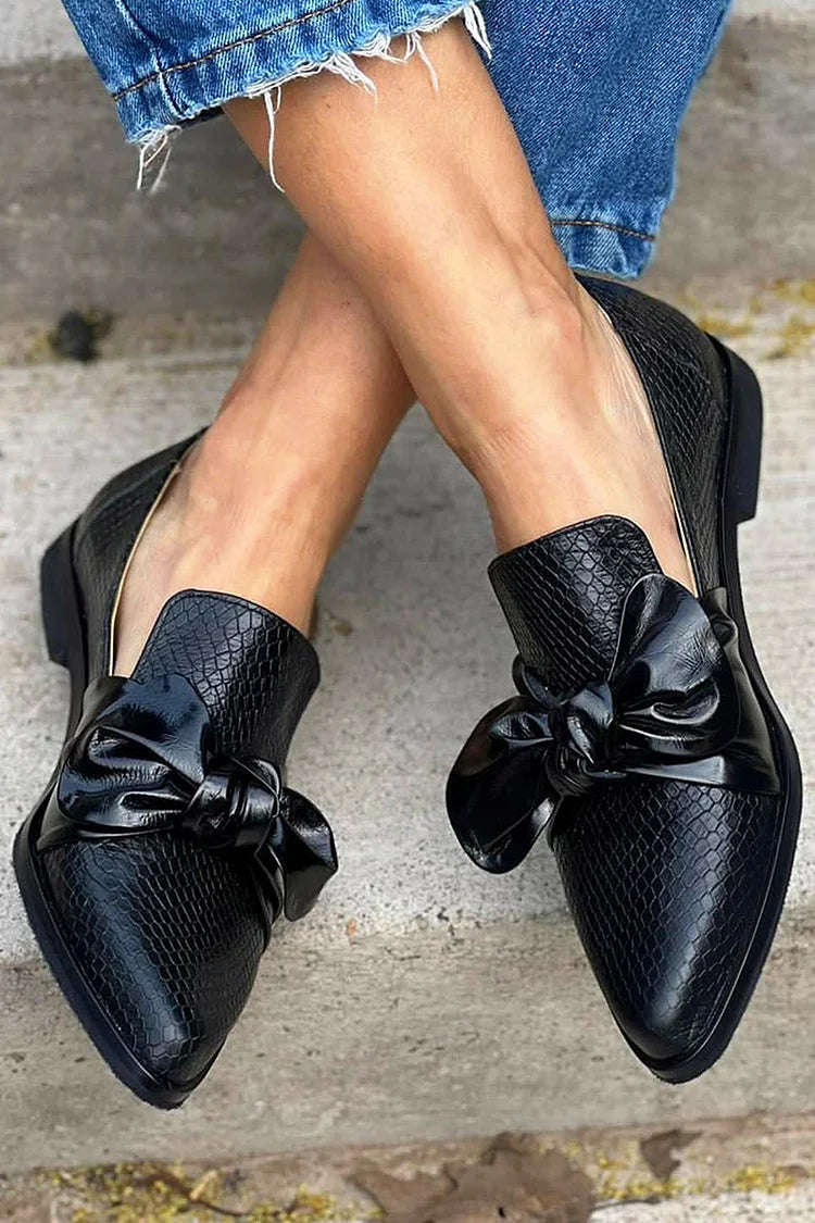 Black loafer with shiny bow
