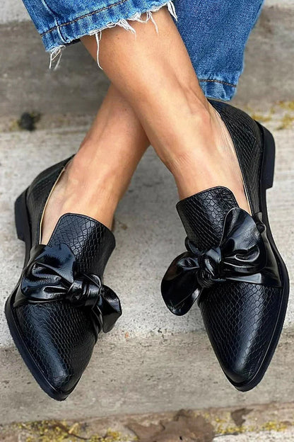 Black loafer with shiny bow