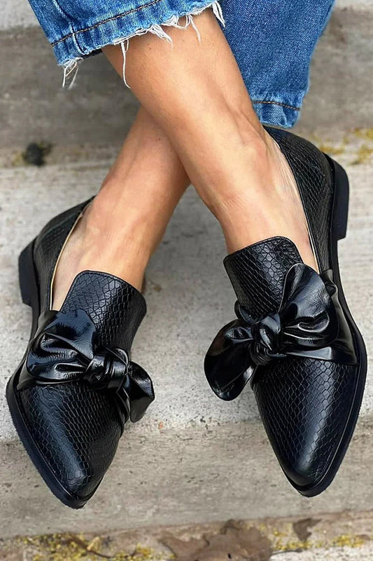 Black loafer with shiny bow