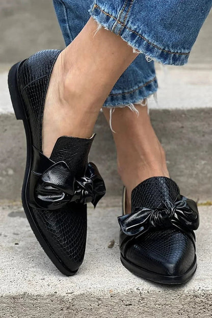 Black loafer with shiny bow